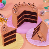 Classic Chocolate Cake with three rich chocolate layers and smooth Swiss Meringue buttercream, beautifully decorated by Crumbs & Doilies.